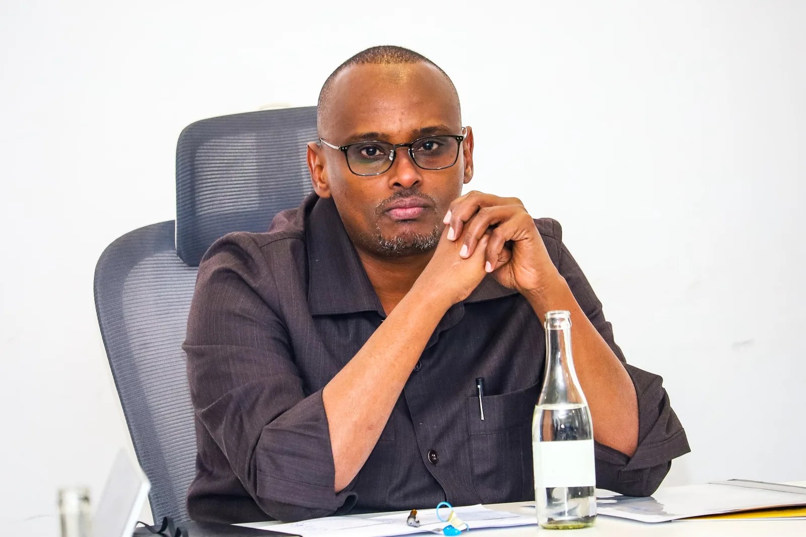 A participant seated at a meeting table.